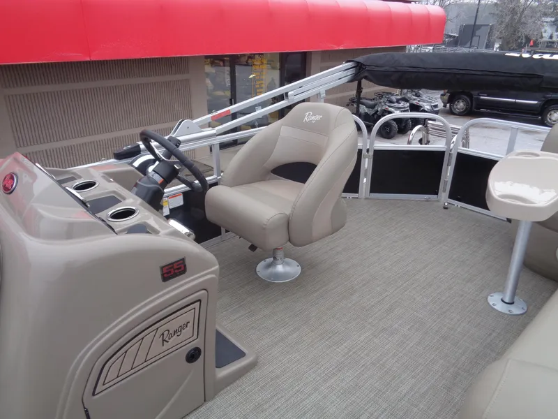 Slide: The Image of 2023 Ranger Reata 200C boat interior with steering console and seating. - 46