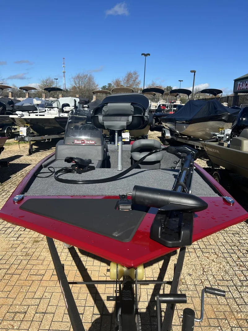 Slide: The Image of 2025 Tracker Bass Tracker Classic XL boat in showroom, featuring red and gray design. - 3