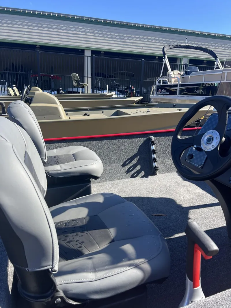 Slide: The Image of 2025 Tracker Bass Tracker Classic XL boat interior with steering wheel and seats. - 5