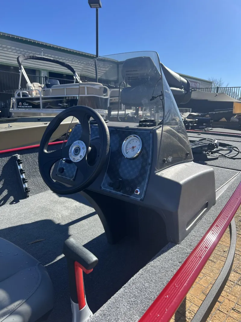 Slide: The Image of 2025 Tracker Bass Tracker Classic XL boat dashboard with steering wheel and gauges. - 6