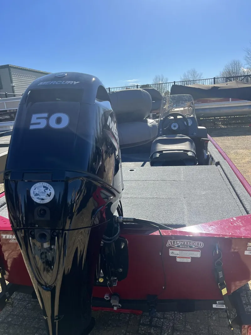Slide: The Image of 2025 Tracker Bass Tracker Classic XL boat with 50 HP engine, parked outdoors. - 7