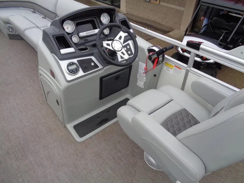 Slide: The Image of 2023 Ranger Reata 220C boat interior with steering console and seating. - 10