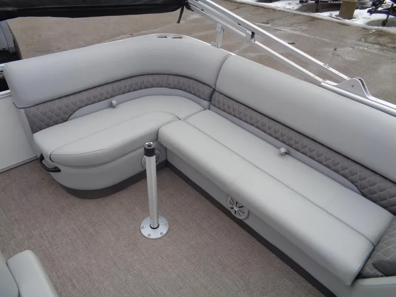 Slide: The Image of 2023 Ranger Reata 220C boat interior with gray cushioned seating. - 11