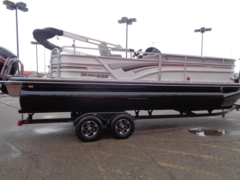 Slide: The Image of 2023 Ranger Reata 220C pontoon boat on trailer in parking lot. - 3