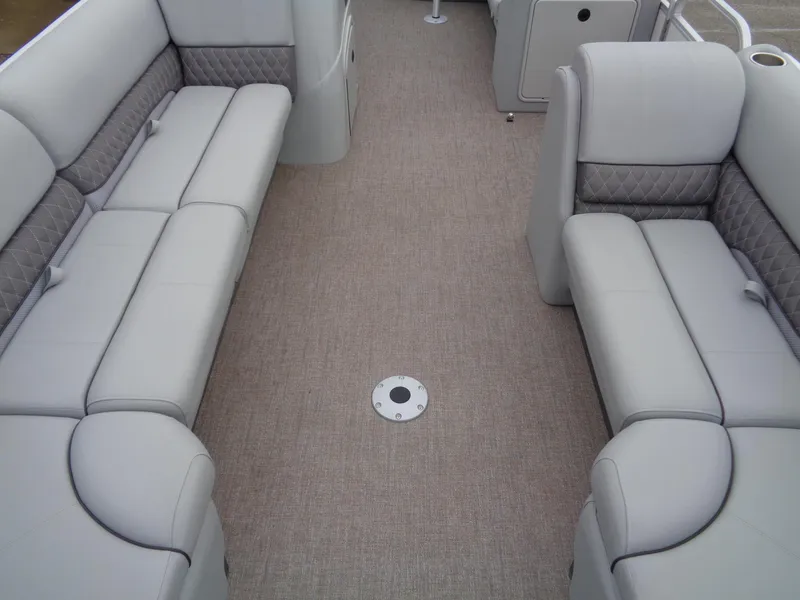 Slide: The Image of 2023 Ranger Reata 220C interior with beige seating and carpet flooring. - 5