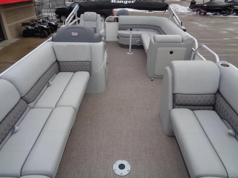 Slide: The Image of 2023 Ranger Reata 220C pontoon boat interior with gray seating and spacious layout. - 6
