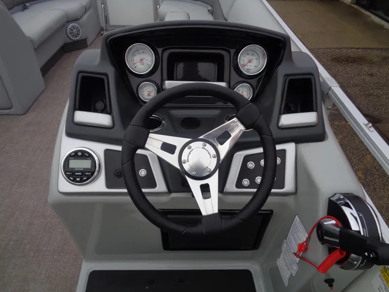 Slide: The Image of 2023 Ranger Reata 220C boat dashboard with steering wheel and gauges. - 9
