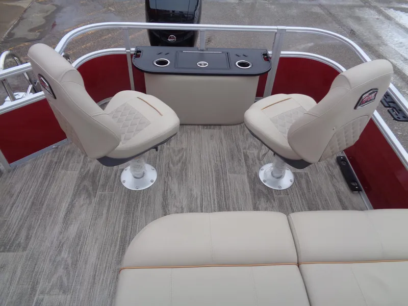 Slide: The Image of 2024 Ranger Reata 220F boat interior with beige seating and wood-style flooring. - 10