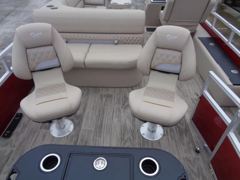 Slide: The Image of 2024 Ranger Reata 220F boat interior with beige seating and table. - 11