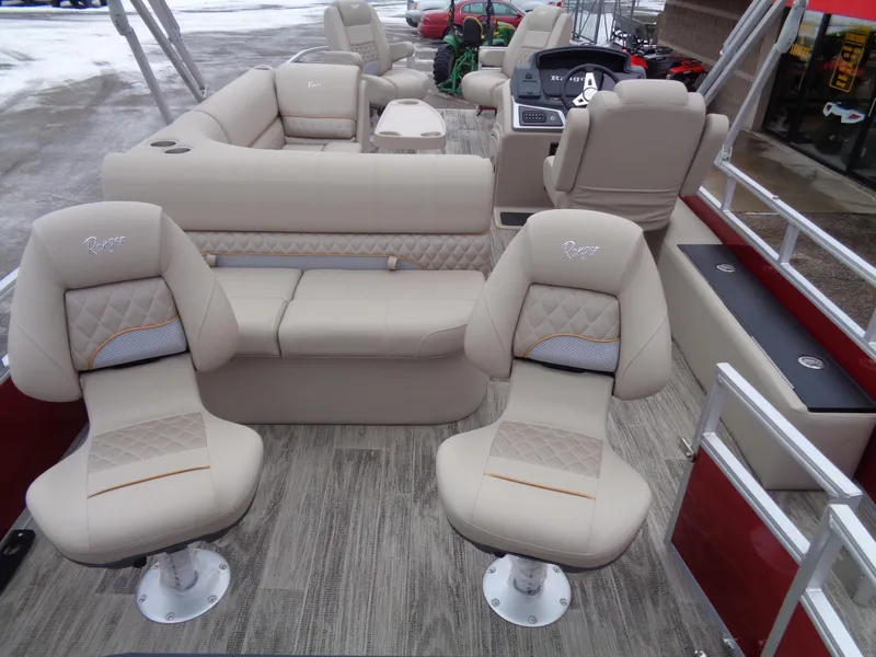 Slide: The Image of 2024 Ranger Reata 220F boat interior with beige seating and modern dashboard. - 12
