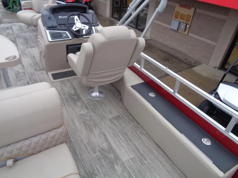 Slide: The Image of 2024 Ranger Reata 220F boat interior with beige seating and modern helm controls. - 13