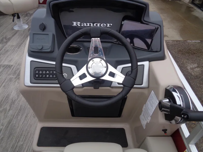 Slide: The Image of 2024 Ranger Reata 220F boat dashboard with steering wheel and control panel. - 14