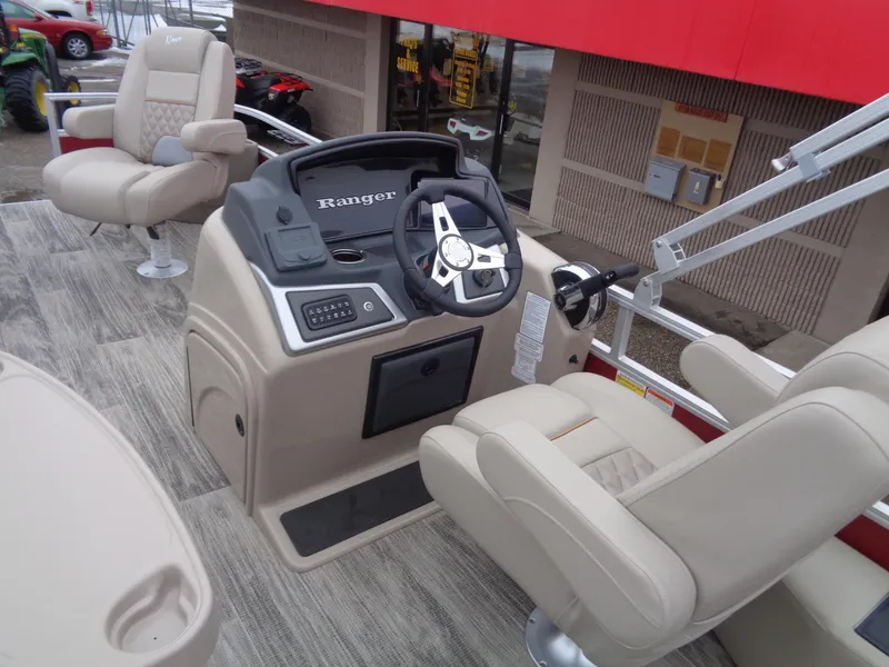 Slide: The Image of 2024 Ranger Reata 220F boat interior with steering console and seating. - 15