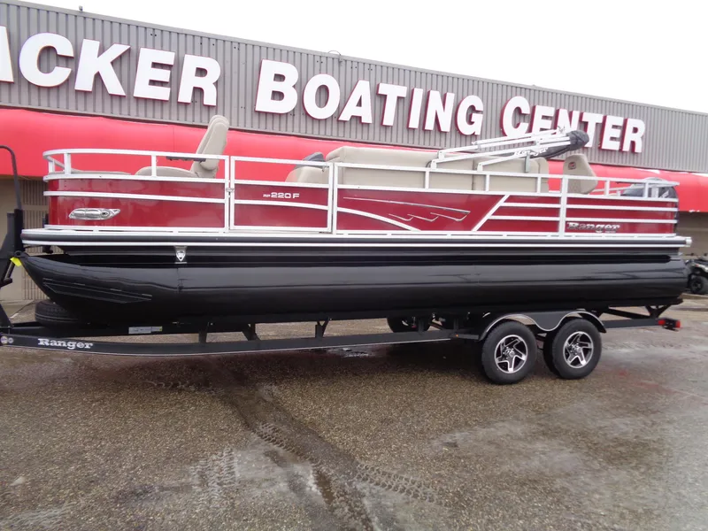 Slide: The Image of 2024 Ranger Reata 220F pontoon boat on trailer at dealership. - 2