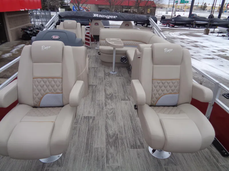 Slide: The Image of 2024 Ranger Reata 220F boat interior with beige seating and wood-style flooring. - 6