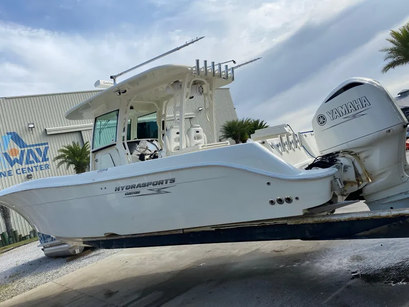 Slide: The Image of 2017 Hydra-Sports 3400 Center Console boat with Yamaha engine, docked near a marine center. - 1