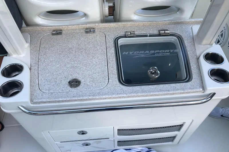Slide: The Image of 2017 Hydra-Sports 3400 Center Console boat interior with storage and cup holders. - 22