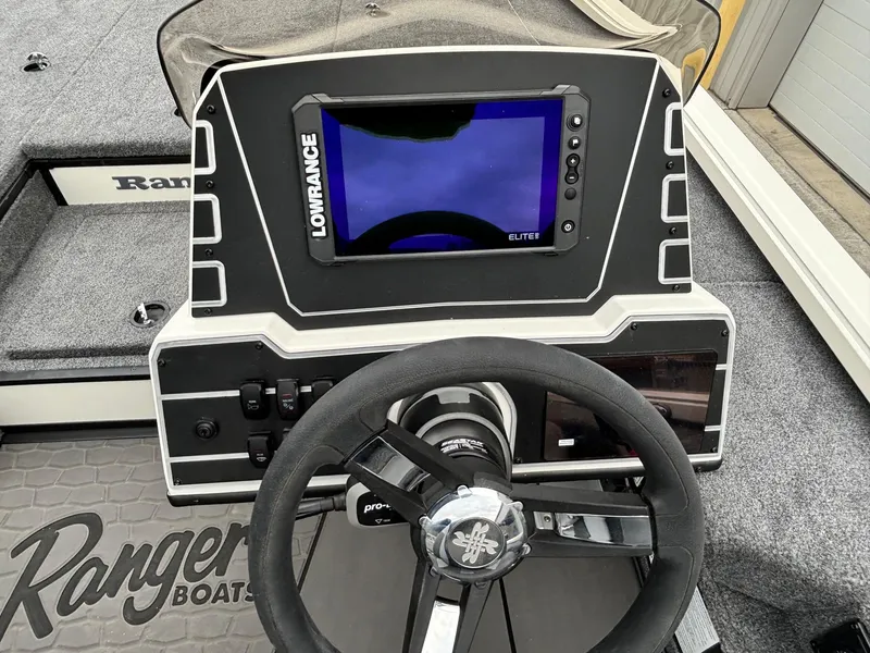 Slide: The Image of Ranger ALPHA 208 boat dashboard with Lowrance Elite display, steering wheel, and controls, 2025 model. - 11