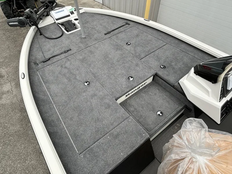 Slide: The Image of 2025 Ranger ALPHA 208 boat interior with gray carpeted deck and storage compartments. - 4