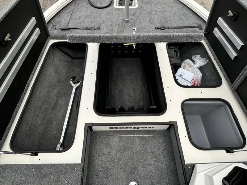 Slide: The Image of 2025 Ranger ALPHA 208 boat interior with storage compartments and fishing gear. - 5