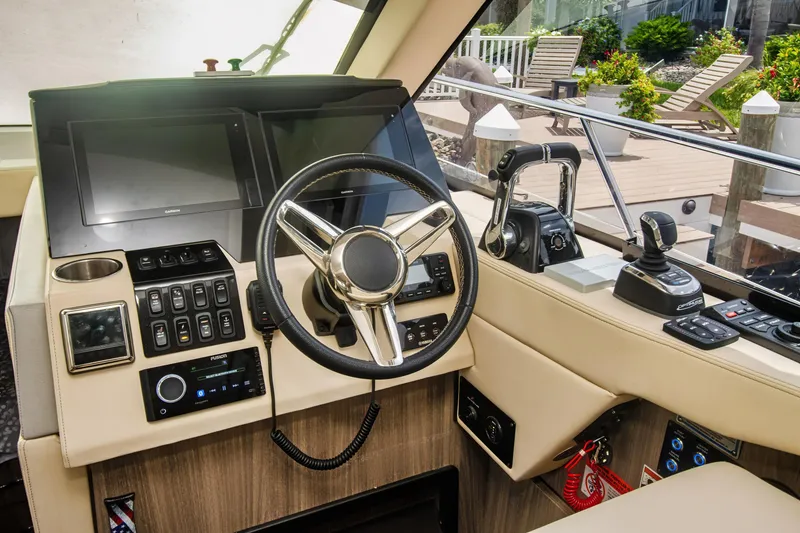 Slide: The Image of 2020 Regal 38 XO yacht helm with modern controls and steering wheel. - 18
