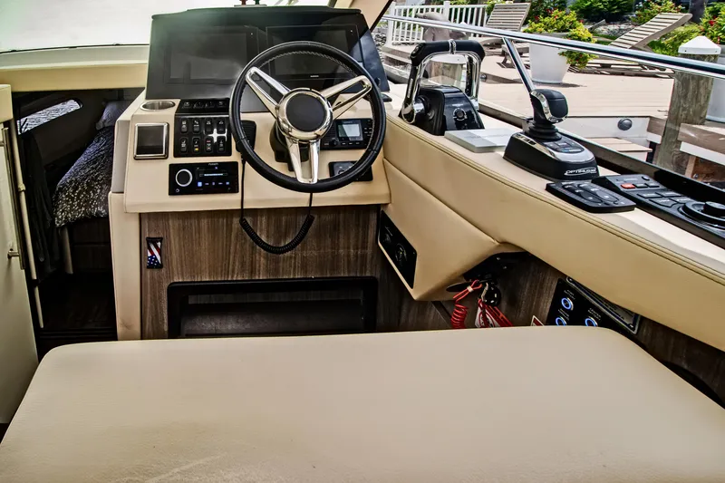 Slide: The Image of 2020 Regal 38 XO yacht helm with modern controls and luxurious interior. - 19