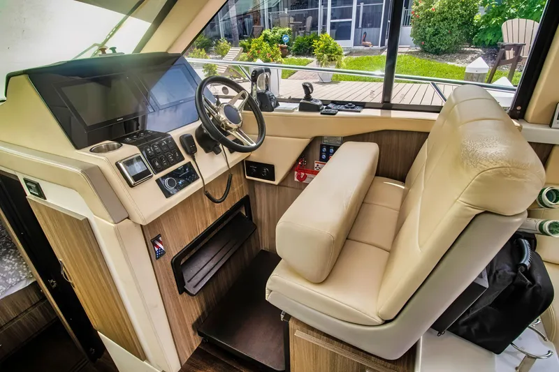 Slide: The Image of 2020 Regal 38 XO yacht helm with modern controls and leather seating. - 20