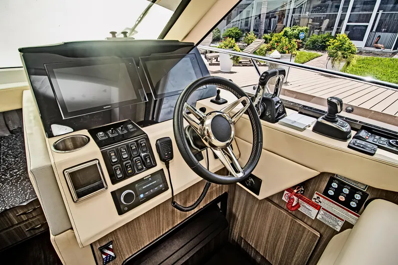 Slide: The Image of 2020 Regal 38 XO yacht helm with modern controls and steering wheel. - 21