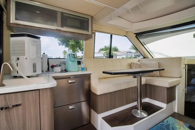 Slide: The Image of 2020 Regal 38 XO yacht interior with kitchenette and seating area. - 24