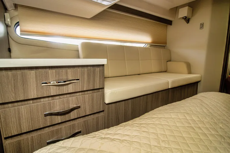 Slide: The Image of Luxurious interior of 2020 Regal 38 XO yacht with beige seating and wood cabinetry. - 30