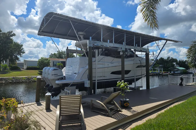 Slide: The Image of 2020 Regal 38 XO boat docked under canopy on a sunny day. - 4