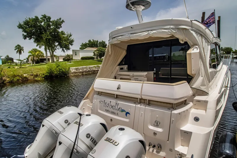 Slide: The Image of 2020 Regal 38 XO yacht docked with Yamaha outboard engines, scenic waterfront view. - 5