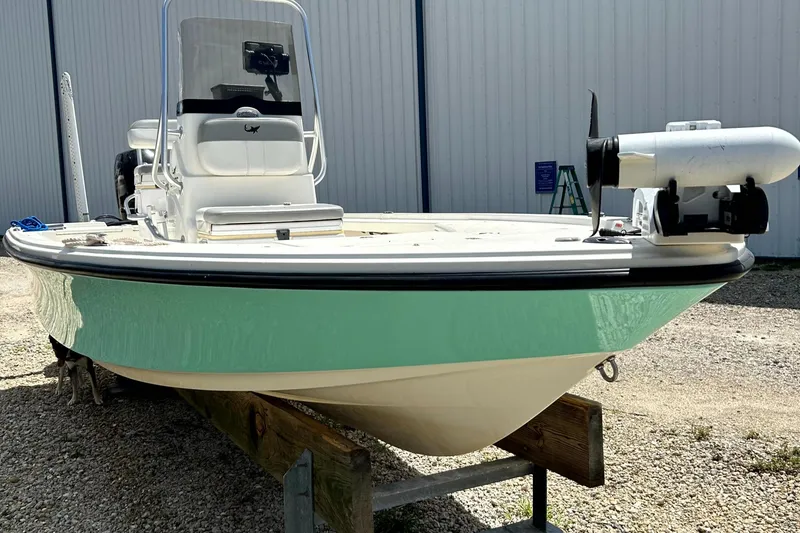 Slide: The Image of 2018 Mako 21LTS boat with mint green hull, parked on gravel. - 0