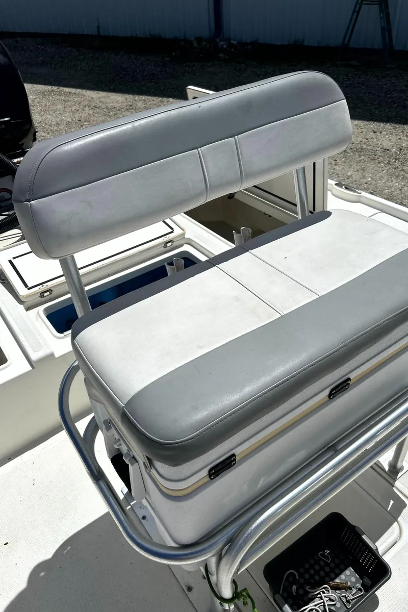 Slide: The Image of 2018 Mako 21LTS boat seat with gray upholstery and storage compartment. - 16
