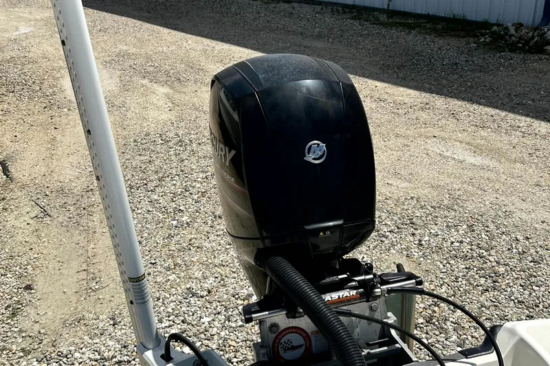 Slide: The Image of 2018 Mako 21LTS boat with Mercury outboard motor on gravel surface. - 5
