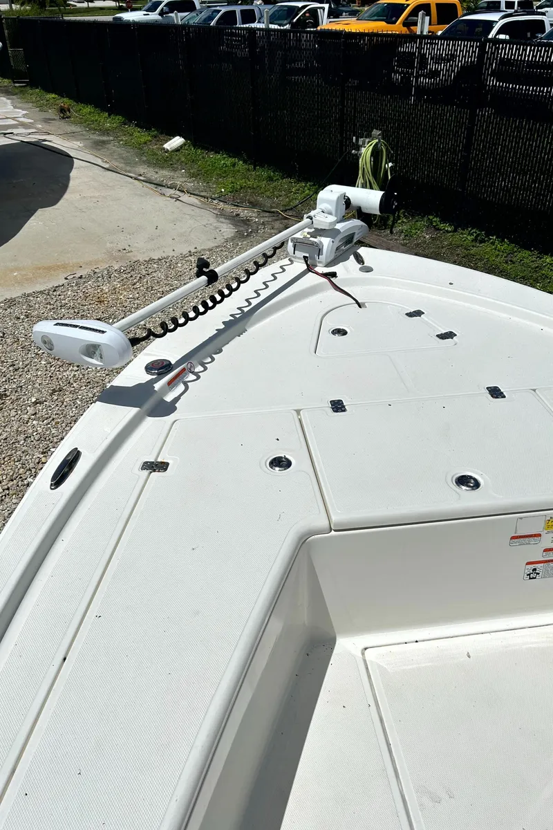 Slide: The Image of 2018 Mako 21LTS boat deck with trolling motor, parked outdoors. - 9