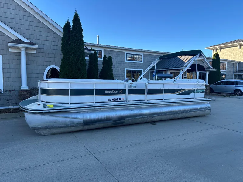 The Image of 2000 Harris EURO CLASSIC pontoon boat parked outside a building. - 1