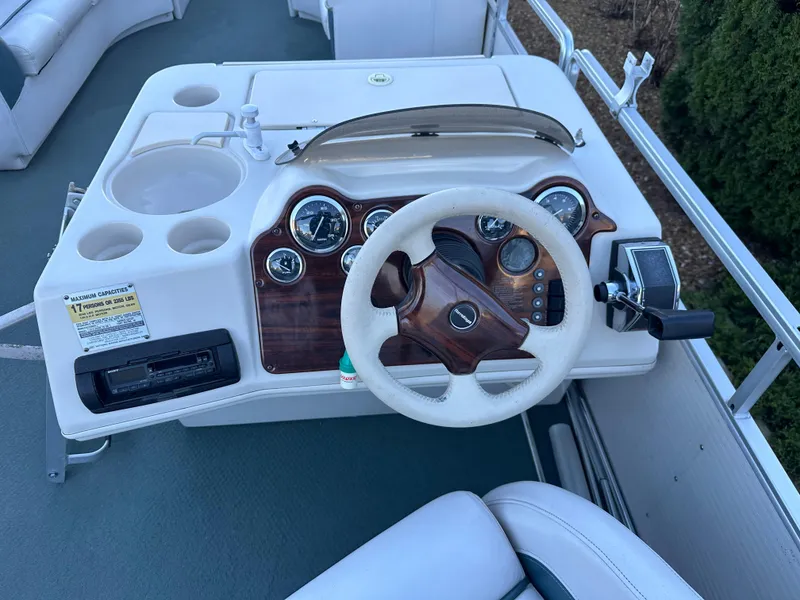 Slide: The Image of Steering console of 2000 Harris EURO CLASSIC boat with gauges and cup holders. - 12