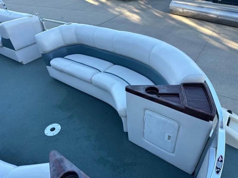 Slide: The Image of 2000 Harris EURO CLASSIC boat interior with white seating and storage compartment. - 3