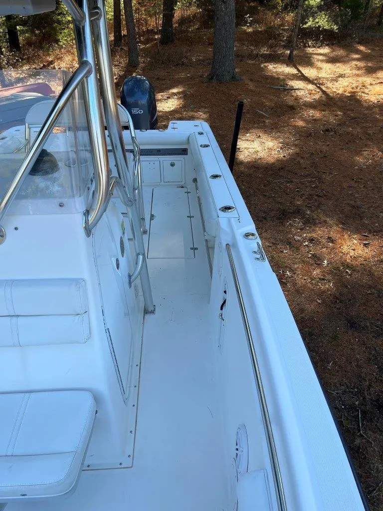 Slide: The Image of 2006 Edgewater 245CC boat deck with trees in the background. - 10