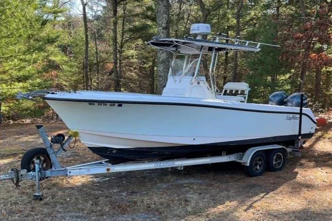 Slide: The Image of 2006 Edgewater 245CC boat on trailer in wooded area. - 4