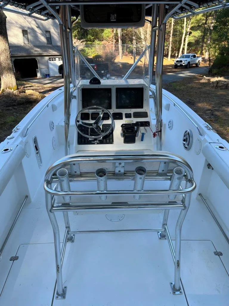 Slide: The Image of 2006 Edgewater 245CC boat interior with steering console and rod holders. - 6