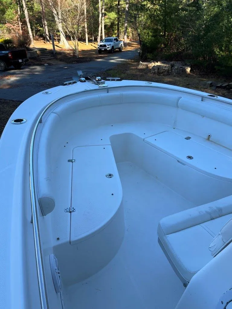 Slide: The Image of 2006 Edgewater 245CC boat with spacious deck, parked outdoors. - 8