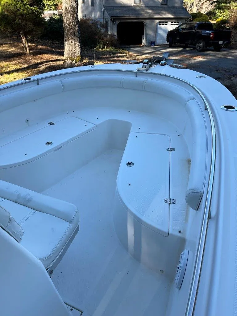 Slide: The Image of 2006 Edgewater 245CC boat with spacious seating, parked in a driveway. - 9