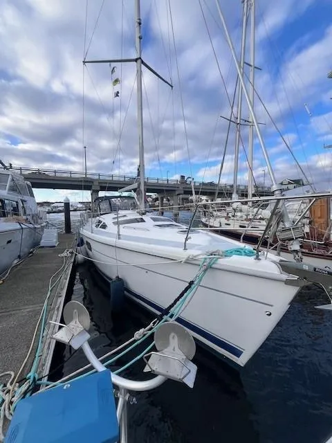 Slide: The Image of Sailboat Hunter 401, 2001 model, docked at marina under cloudy sky. - 11