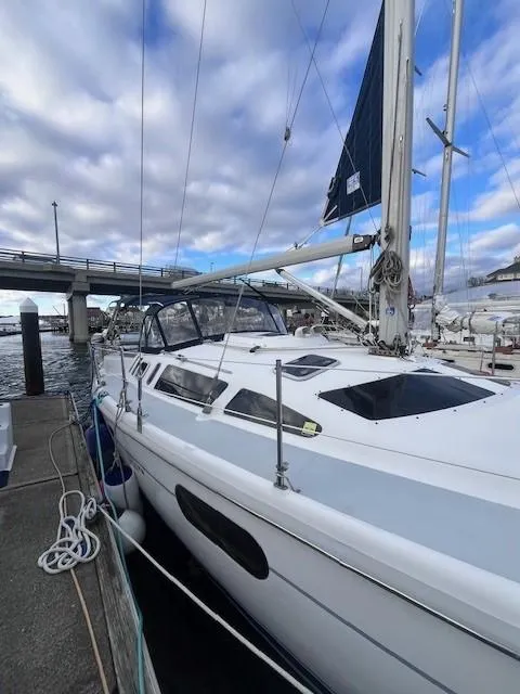 Slide: The Image of 2001 Hunter 401 sailboat docked at marina under cloudy sky. - 12