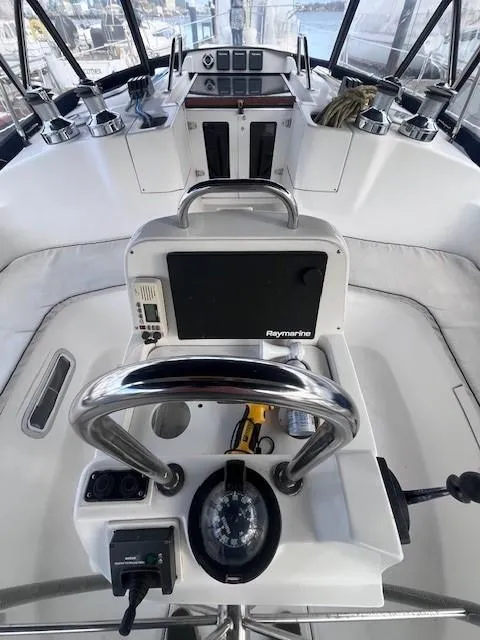 Slide: The Image of Cockpit of 2001 Hunter 401 sailboat with navigation equipment and steering wheel. - 16