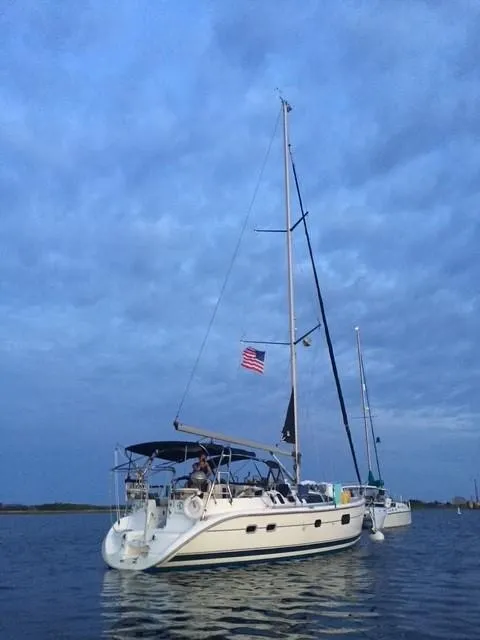 Slide: The Image of Sailboat Hunter 401, 2001 model, anchored on calm water under cloudy sky. - 2