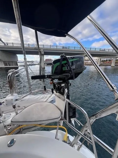 Slide: The Image of Hunter 401 sailboat, 2001 model, with outboard motor, docked near a bridge. - 20