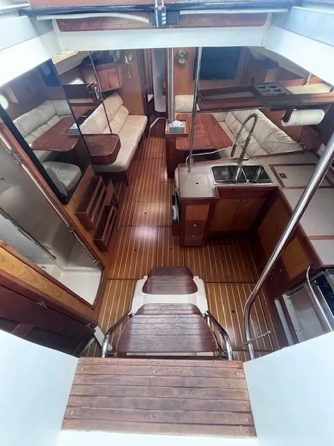 Slide: The Image of Interior of 2001 Hunter 401 yacht with wood flooring and cozy seating area. - 21
